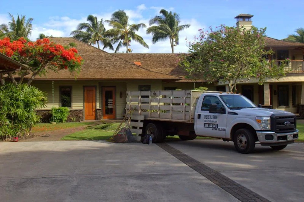 Coconut Kuleana branded service truck at Maui luxury estate palm trimming job site